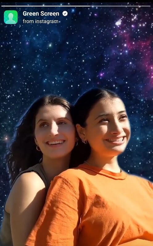 Green Screen feature by Instagram showing two women in the foregrond and an image of gallaxies in the background